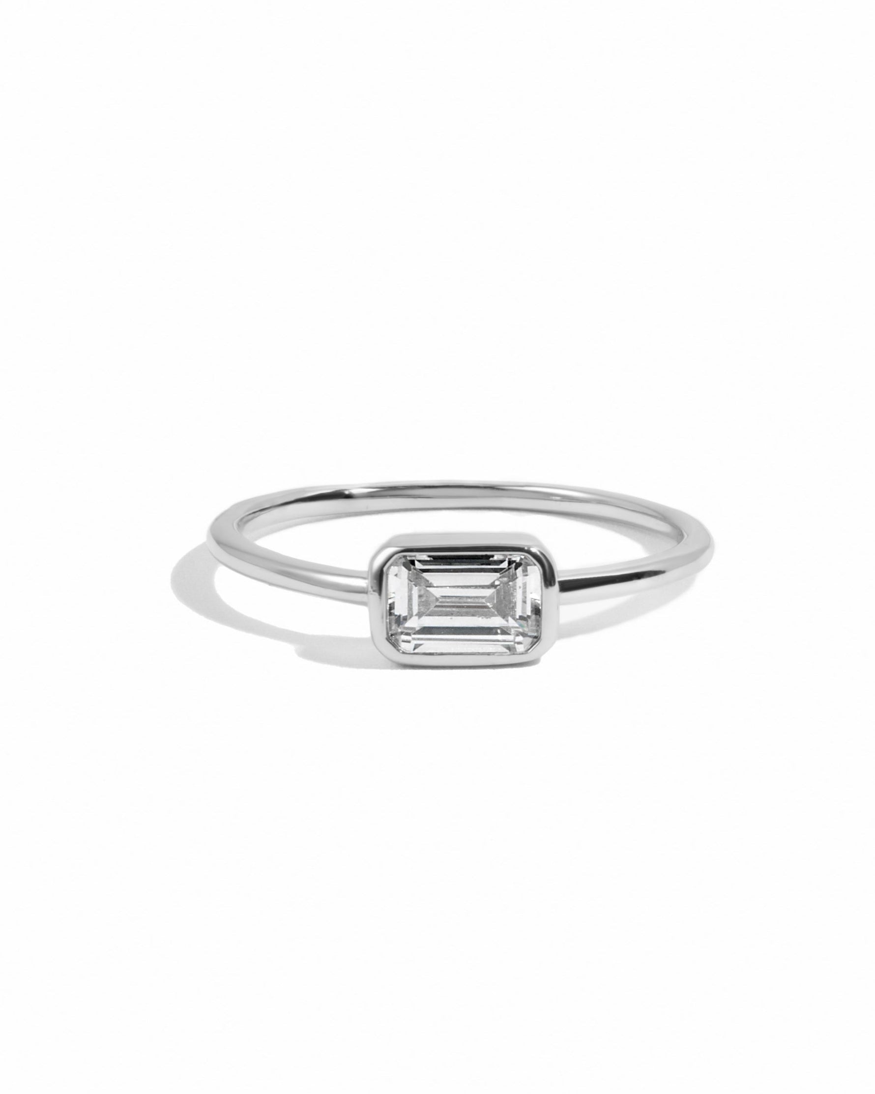 Silver ring with a baguette gemstone on a white background