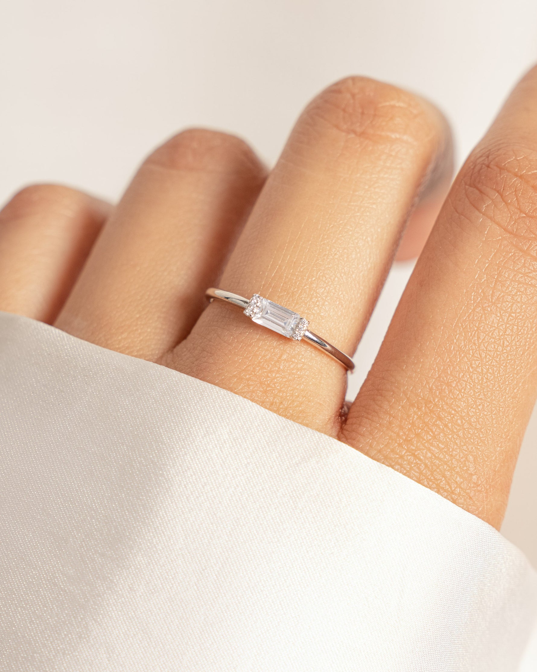 model wearing sterling silver white cz diamond baguette ring