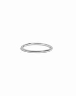 Thin plain sterling silver stacking band on white background.