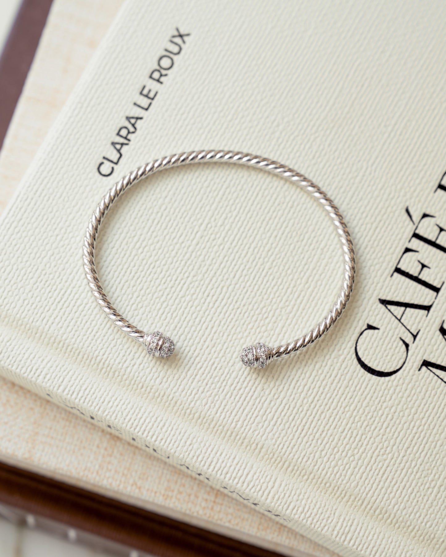 closeup image of silver open cuff bangle bracelet with cubic zirconia stones