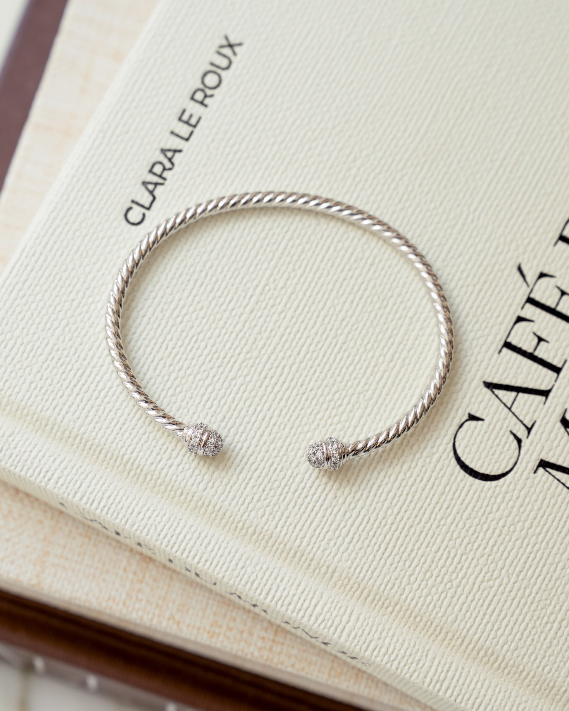 closeup image of silver open cuff bangle bracelet with cubic zirconia stones