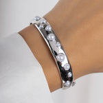 model wearing silver bangle bracelet with pearl design