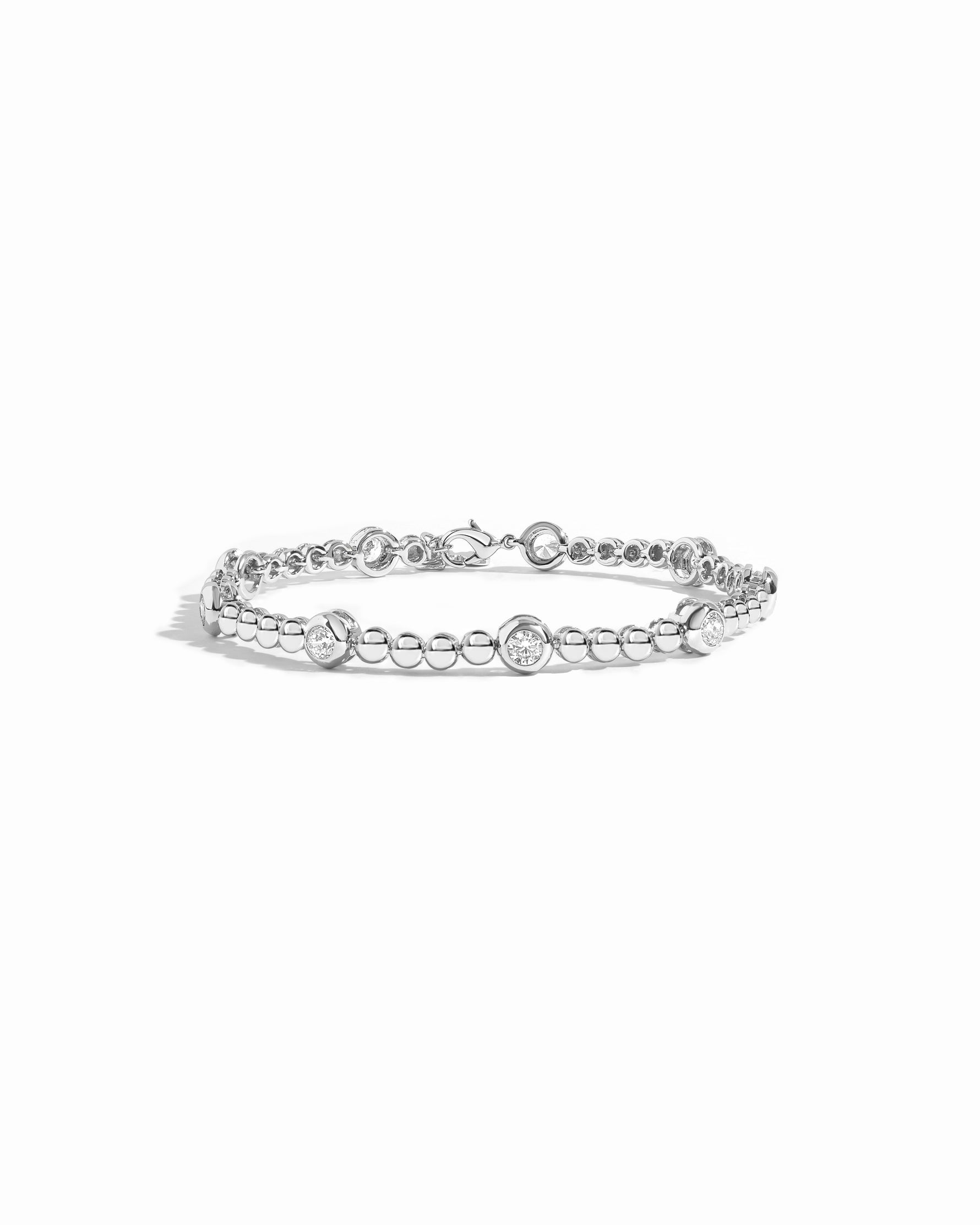 Flat lay of silver bracelet with beads and diamonds. 