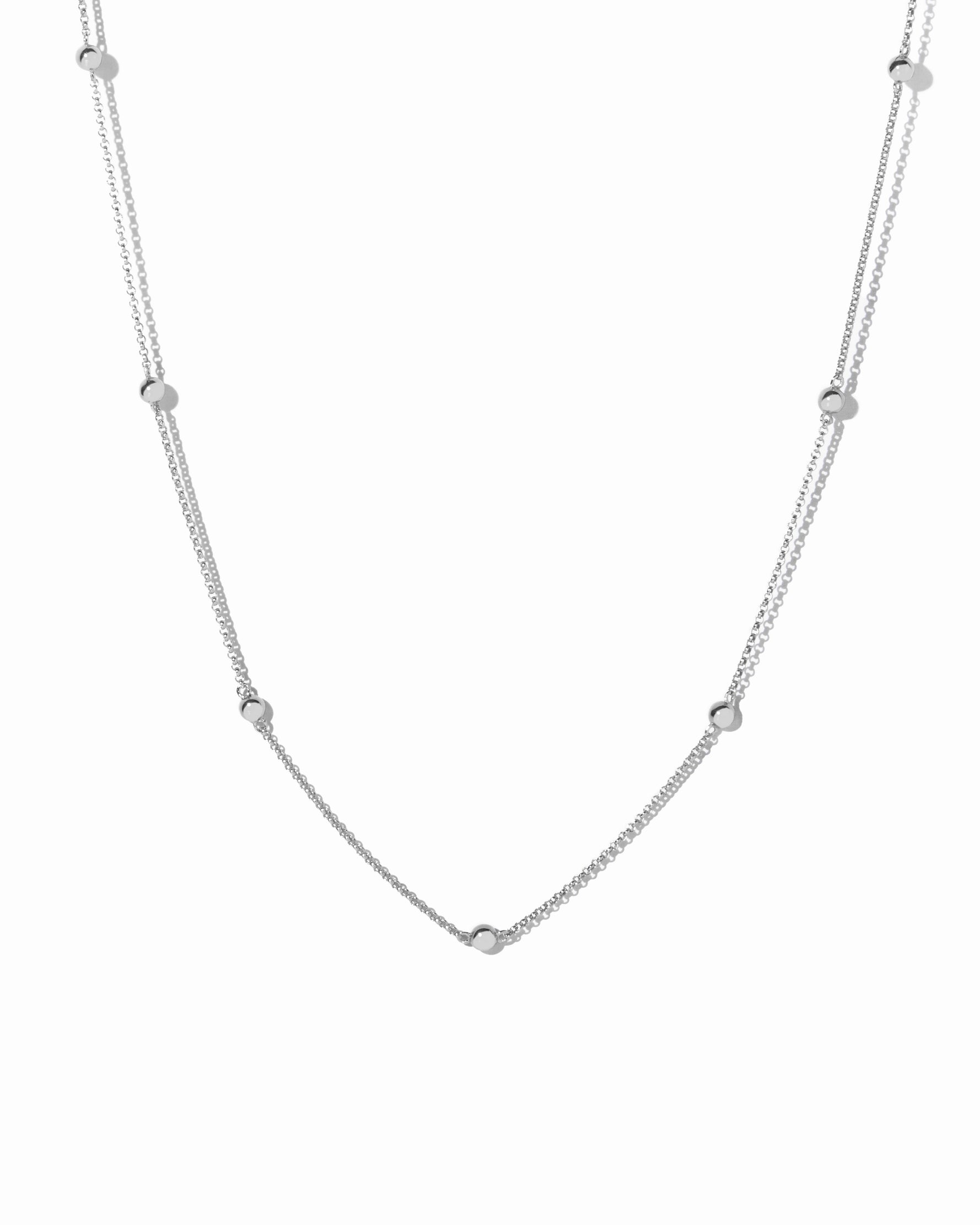 Sterling silver beaded necklace on a white background