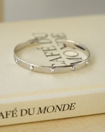 Silver vintage cuff bracelet on a decorative book