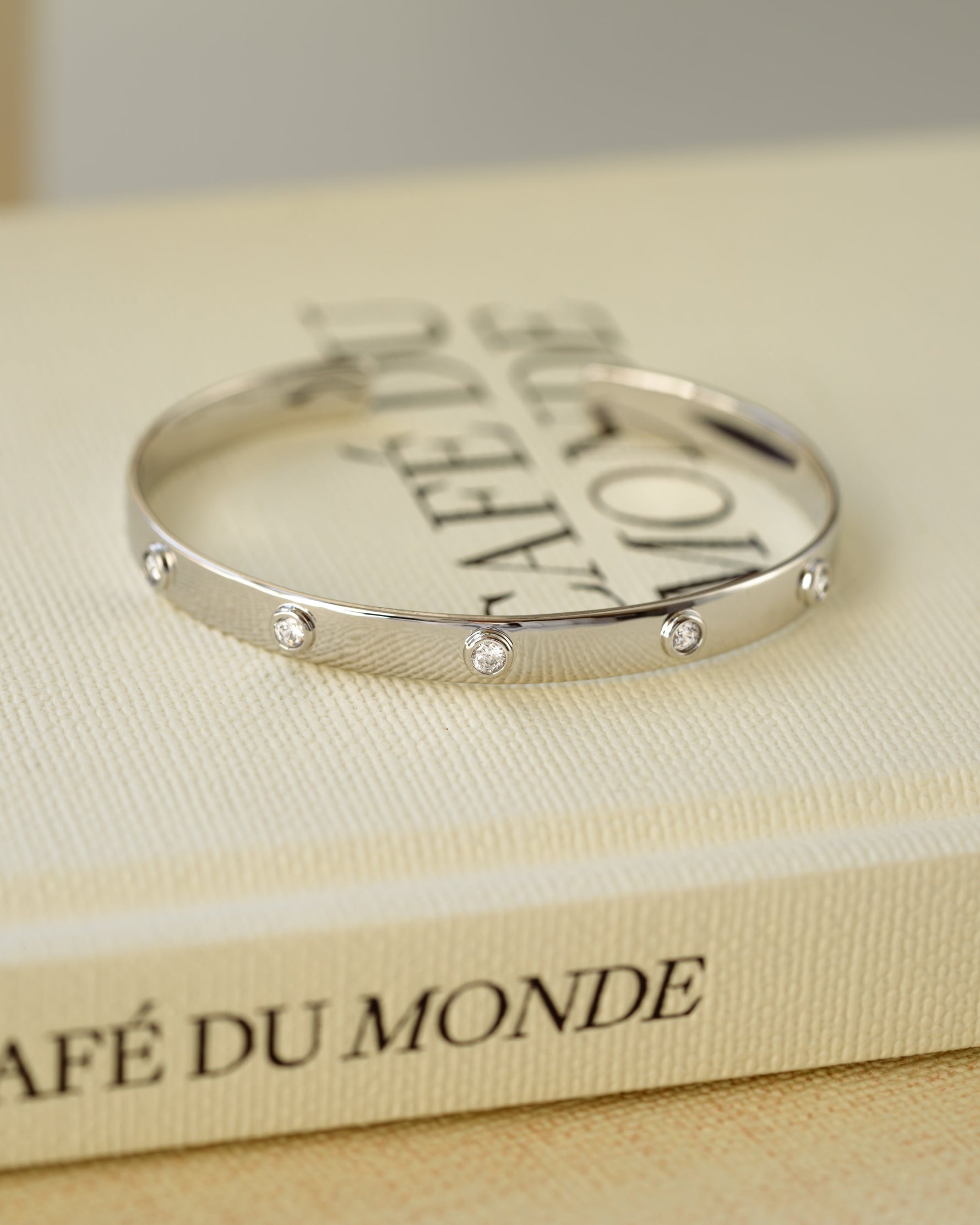 Silver vintage cuff bracelet on a decorative book
