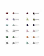 Collection of sterling silver dainty stud earrings with different birthstone colored stones on a white background