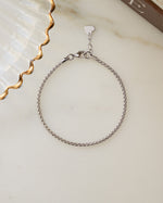 Minimalist silver chain box chain bracelet on marble surface