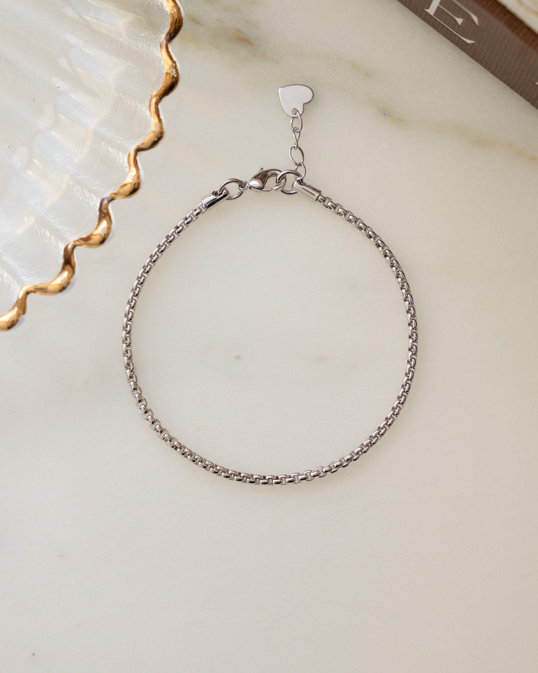Minimalist silver chain box chain bracelet on marble surface