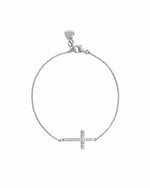 Sterling silver bracelet with a small cross pendant on a white background