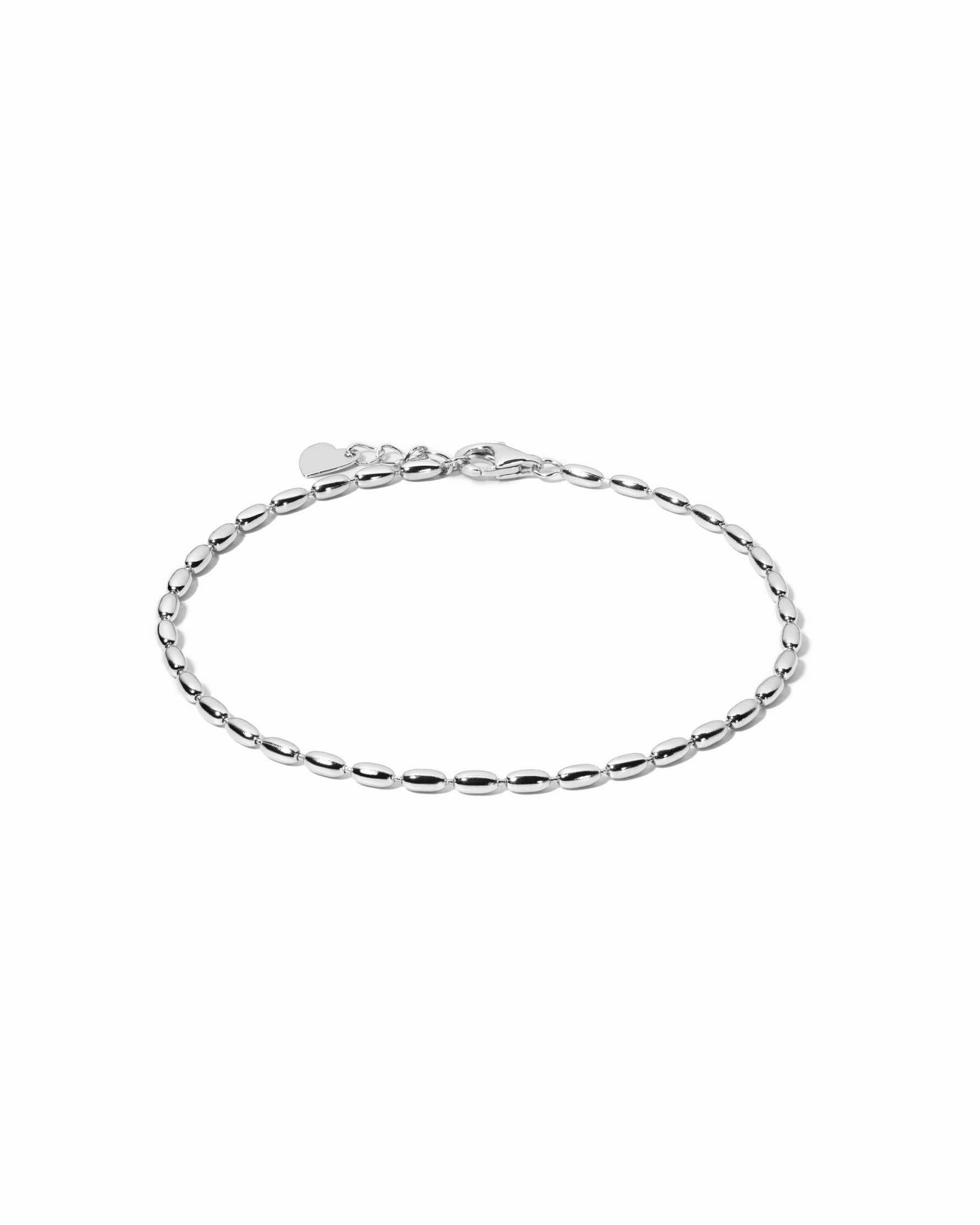 Silver beaded chain bracelet on a white background