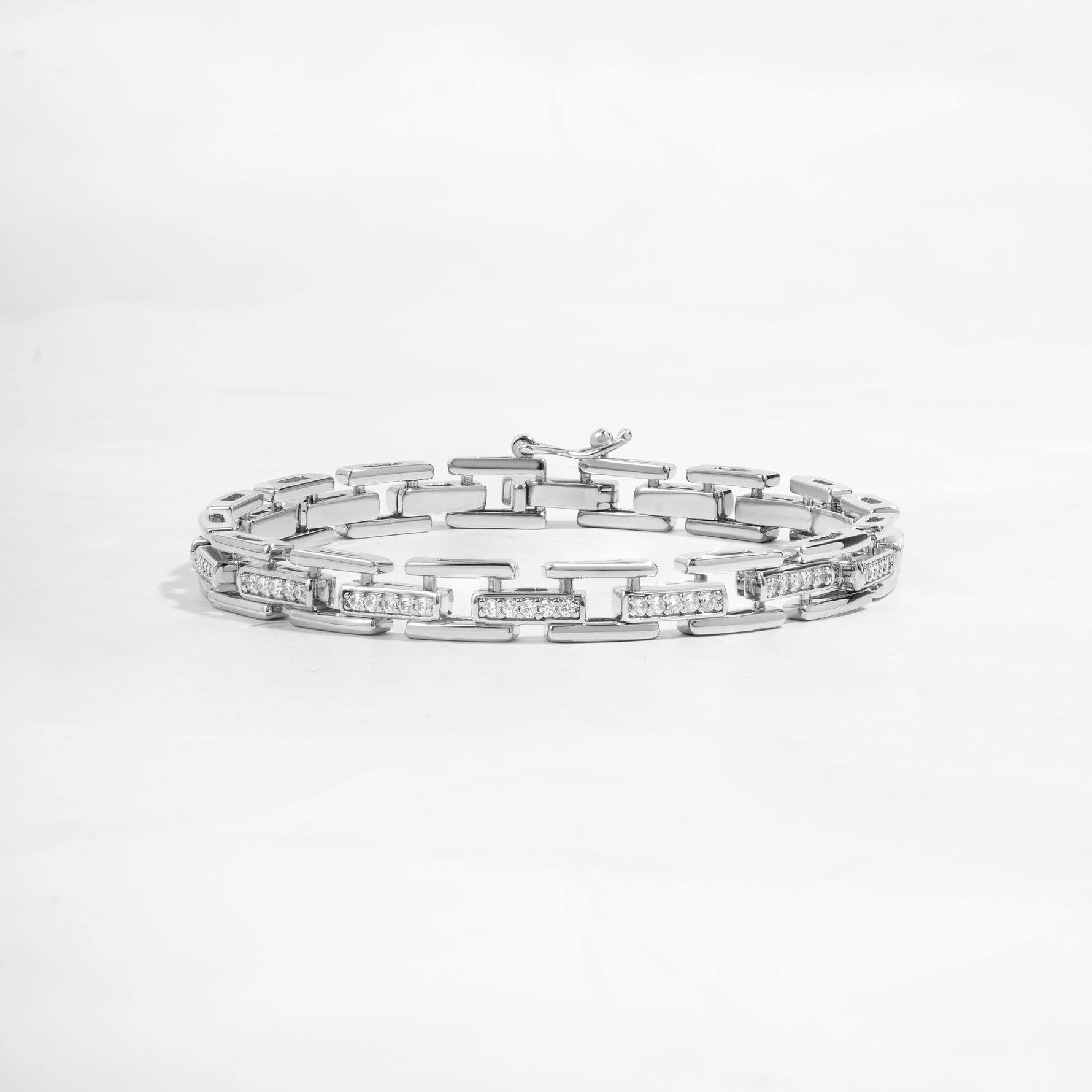 closeup image of statement jewelry featuring a silver chain link bracelet 