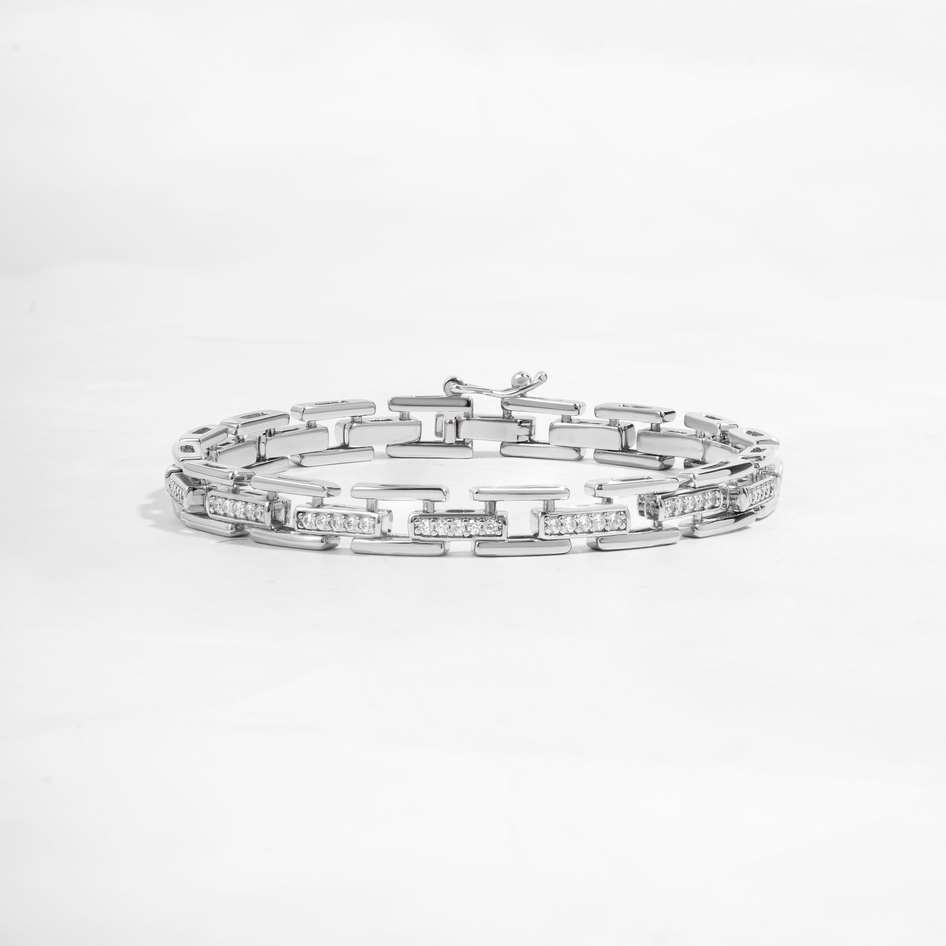 closeup image of statement jewelry featuring a silver chain link bracelet 