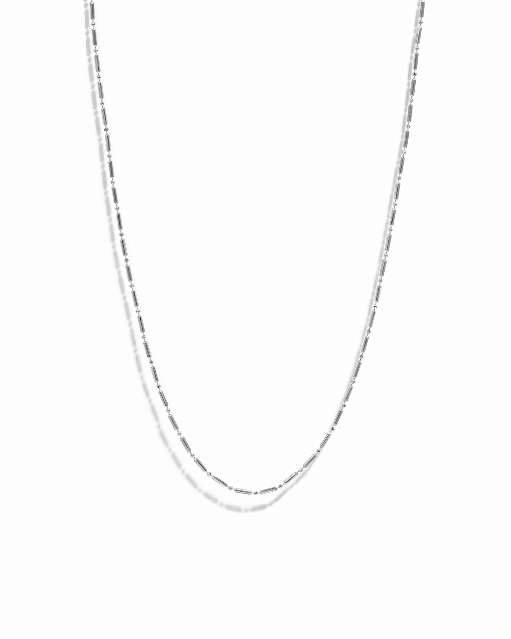 Silver chain necklace on a white background