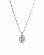 Closeup image of sterling silver diamond engraved necklace with an "S" initial