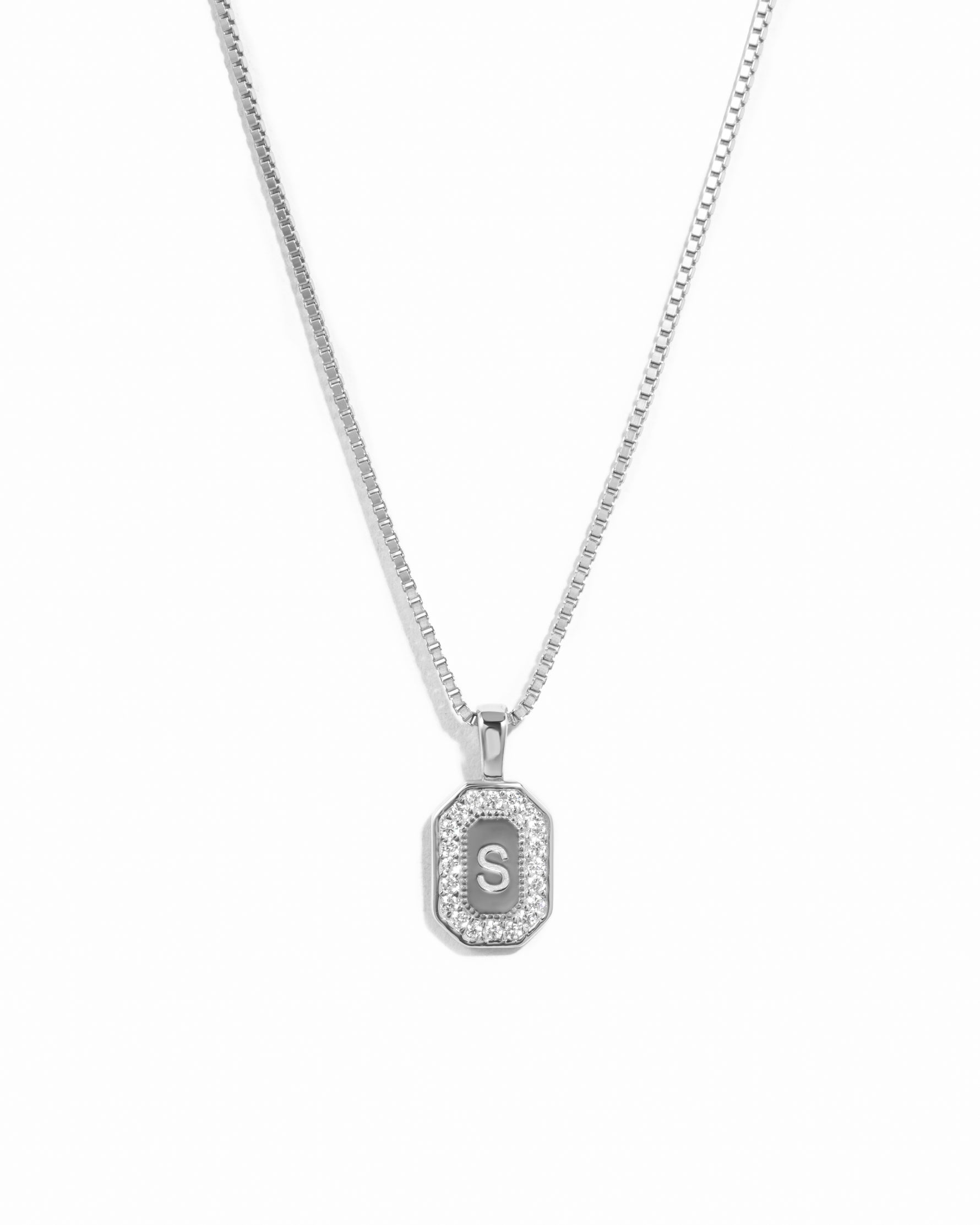Closeup image of sterling silver diamond engraved necklace with an "S" initial