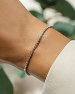 Model wearing dainty silver bracelet