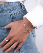 Silver vintage bracelet on model with pearl rings