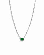 Silver paperclip chain with emerald pendant on white background