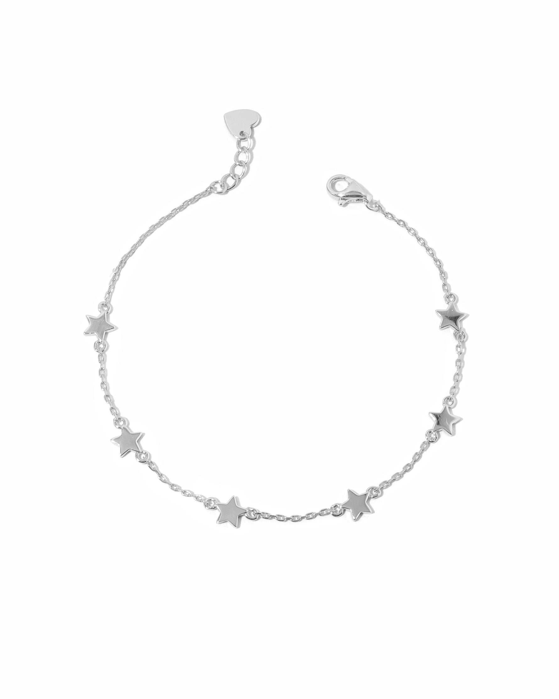 Silver star ankle bracelet on a white background