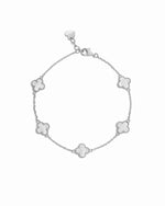 closeup image of silver chain bracelet with mother of pearl clover shaped charms