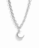 Silver moon statement necklace with tiny diamond accents on chunky diamond chain against a white background
