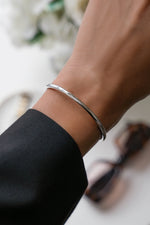 model wearing an adjustable sterling silver cuff bracelet
