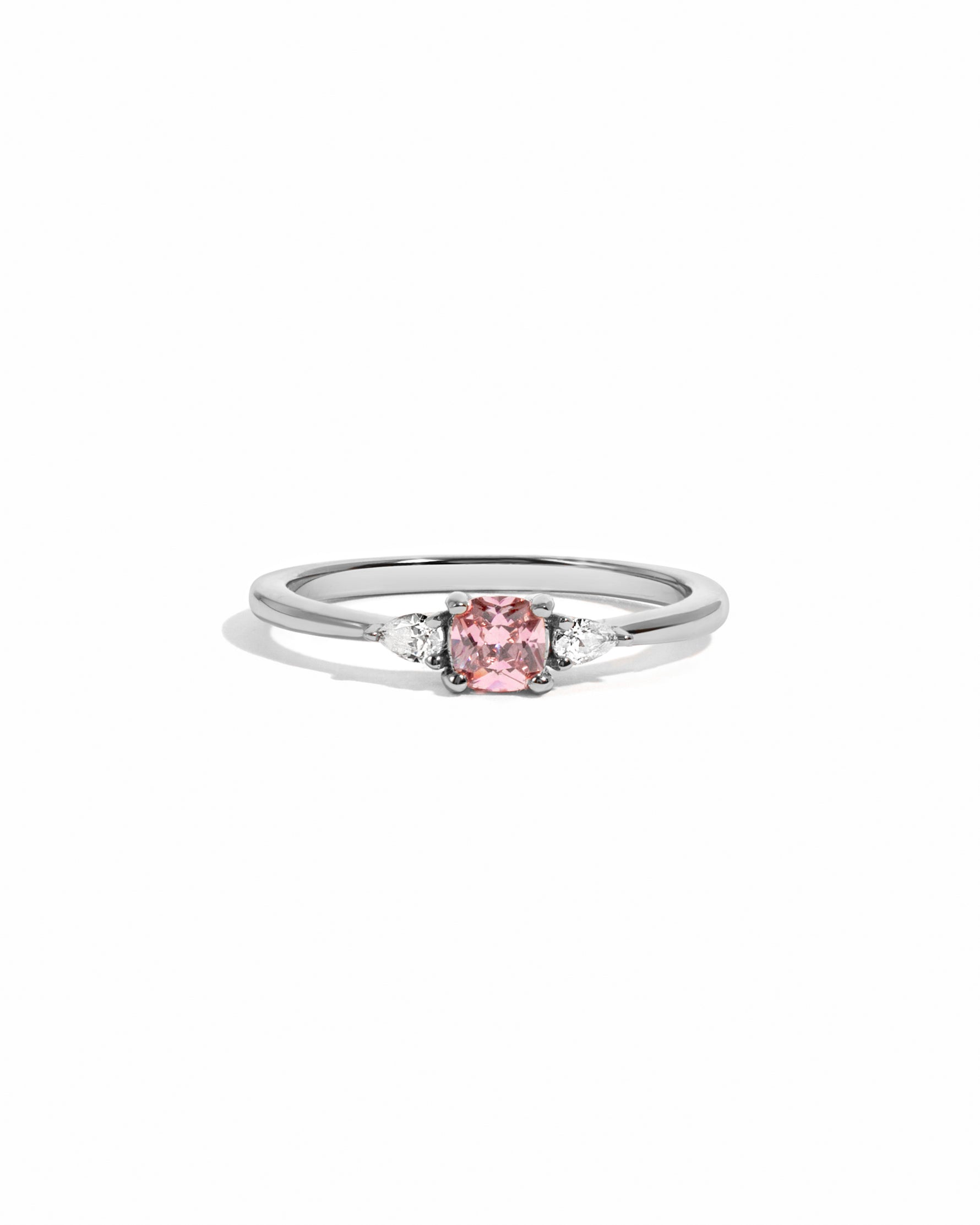 Silver ring with a pink gemstone on a white background