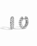 Pair of sterling silver hoop earrings with cubic zirconia gemstones on a white background