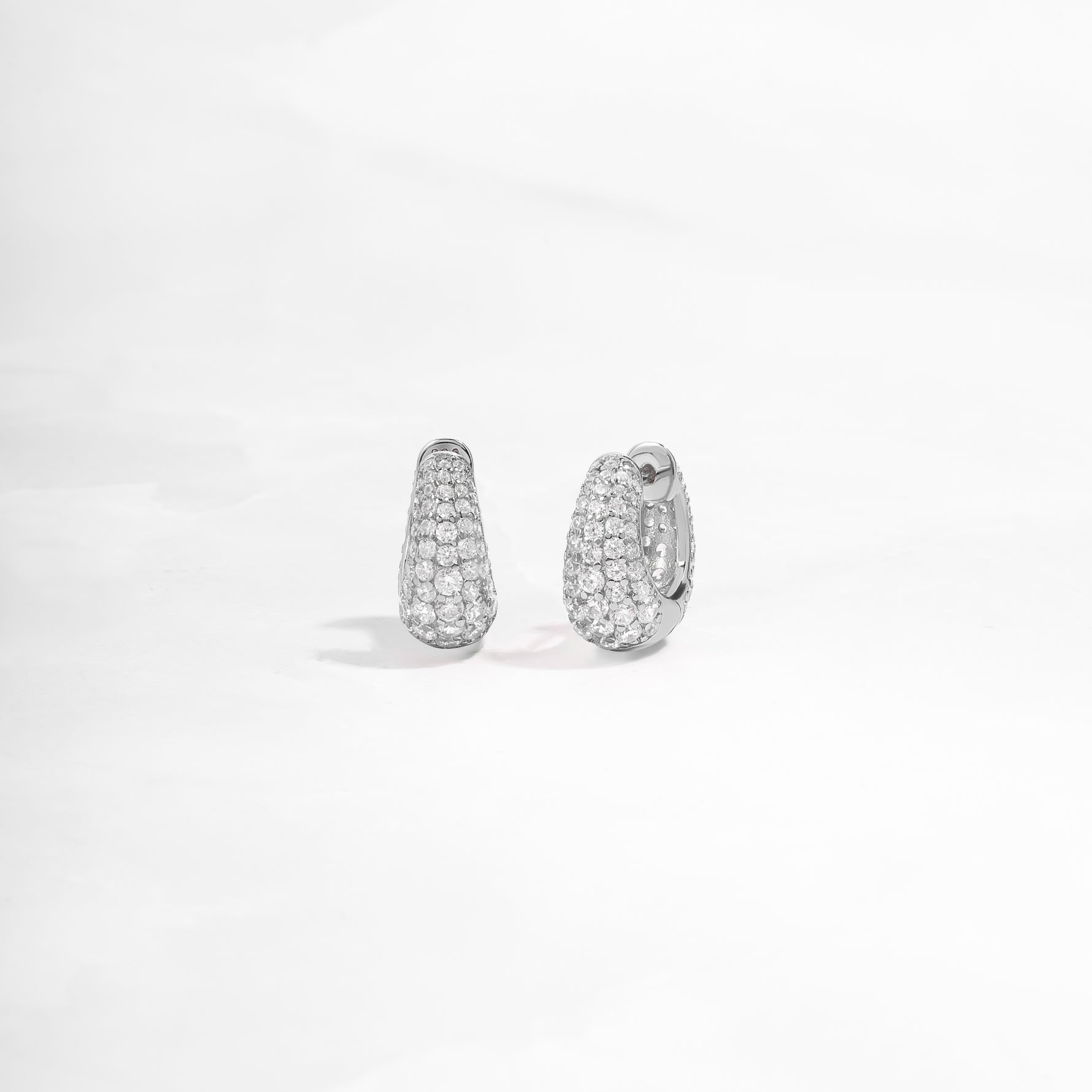 closeup image of sterling silver hoop earrings with cubic zirconia diamonds