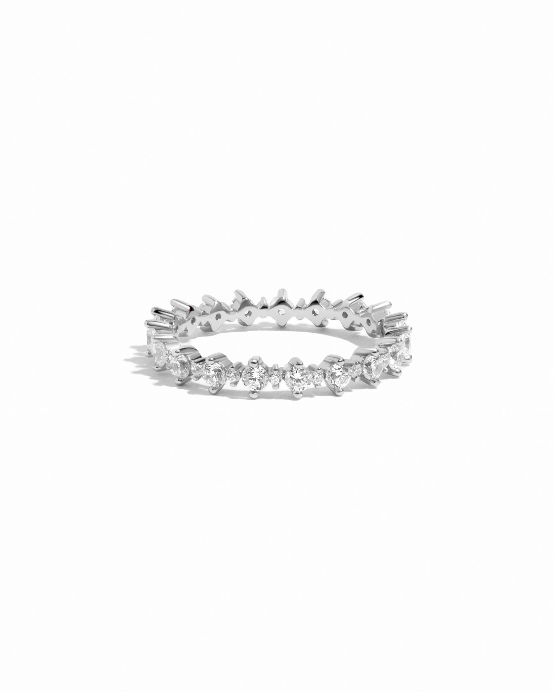 Silver eternity ring with small cz diamonds on a white background