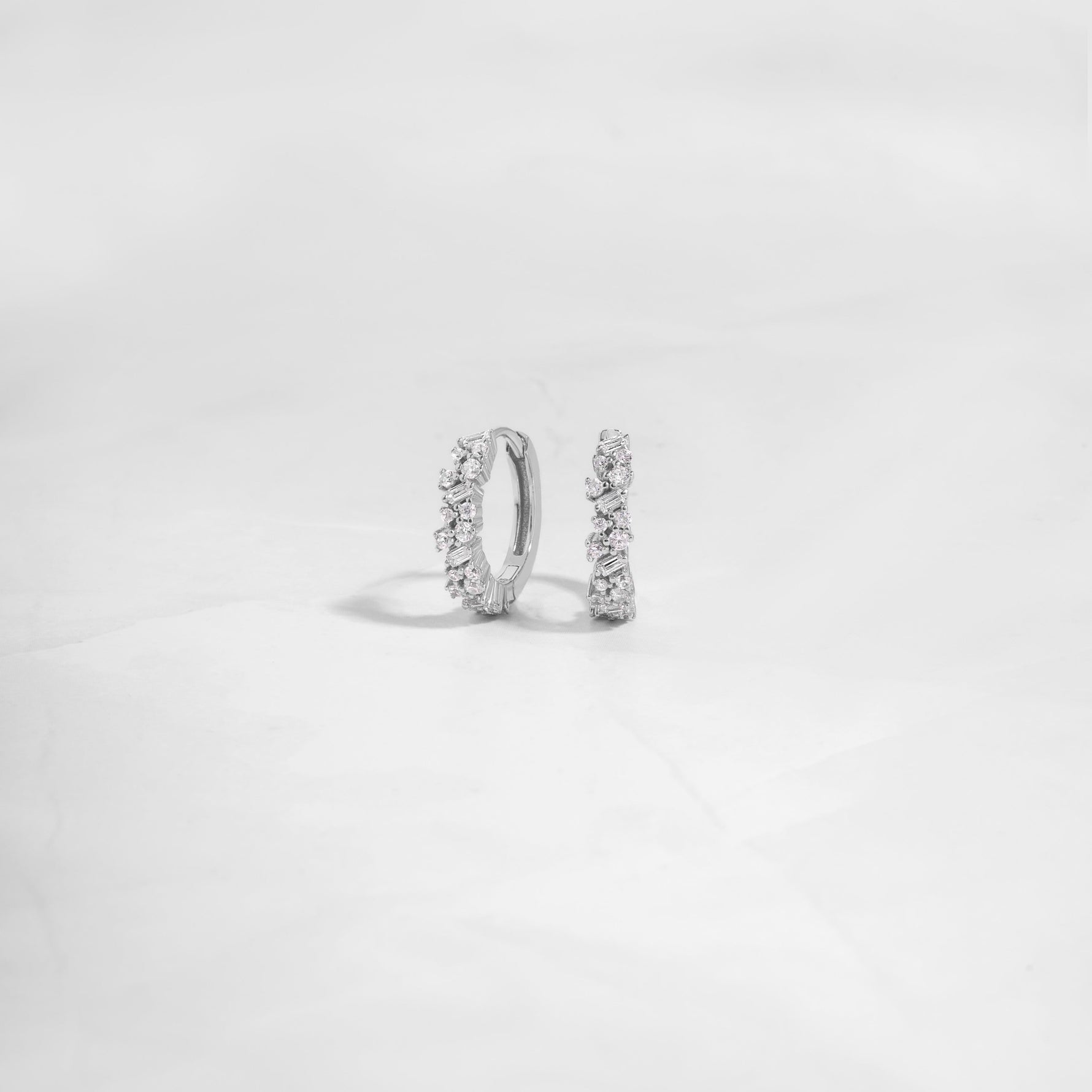 Closeup image of 925 sterling silver diamond huggies