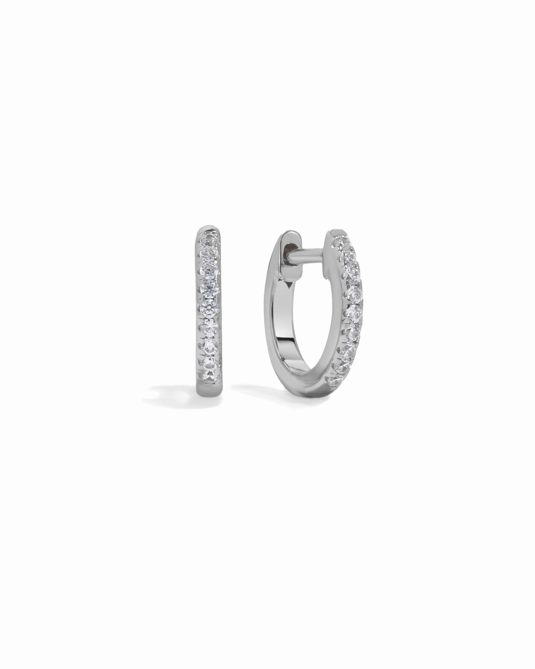 Pair of silver hoop earrings on a white background