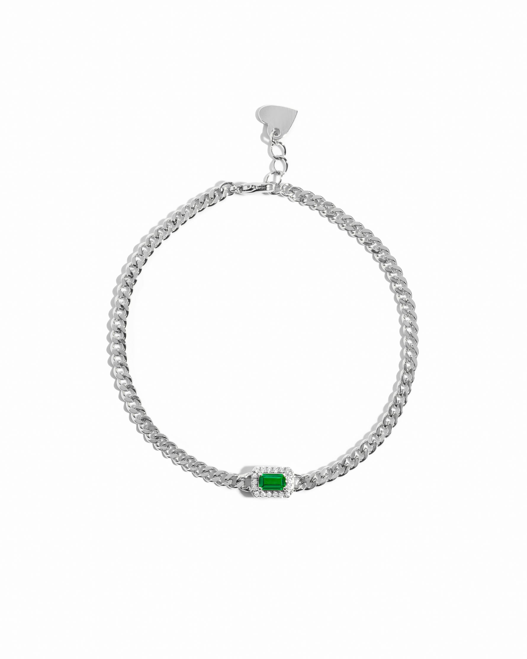 Silver bracelet with a emerald green gemstone on a white background