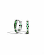 Sterling silver emerald huggie earrings on a white background