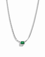 Silver chain necklace with a green gemstone pendant on a white background