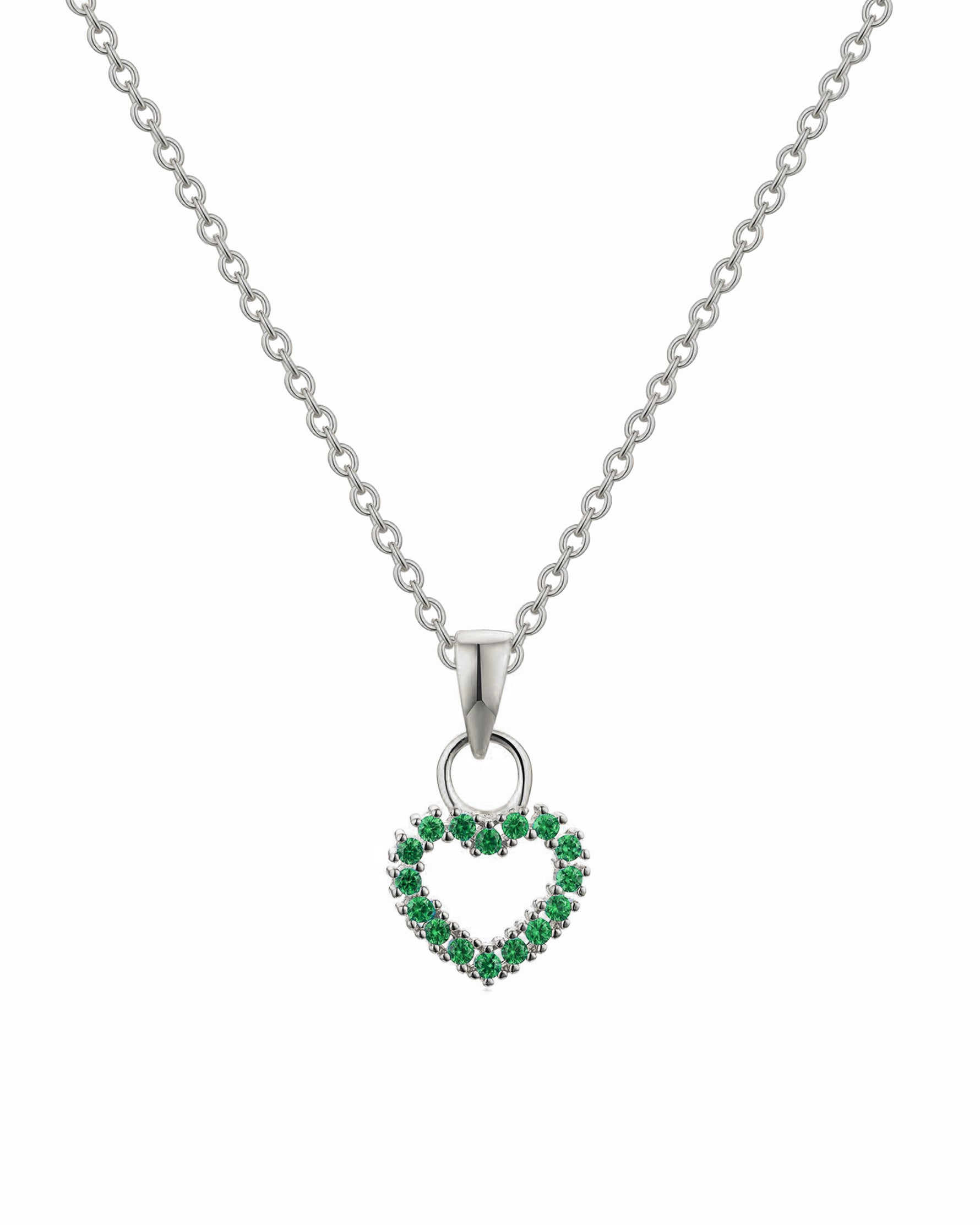 Heart-shaped pendant with green stones on a silver chain against a white background
