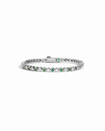 closeup image of white cz and emerald green tennis bracelet in silver