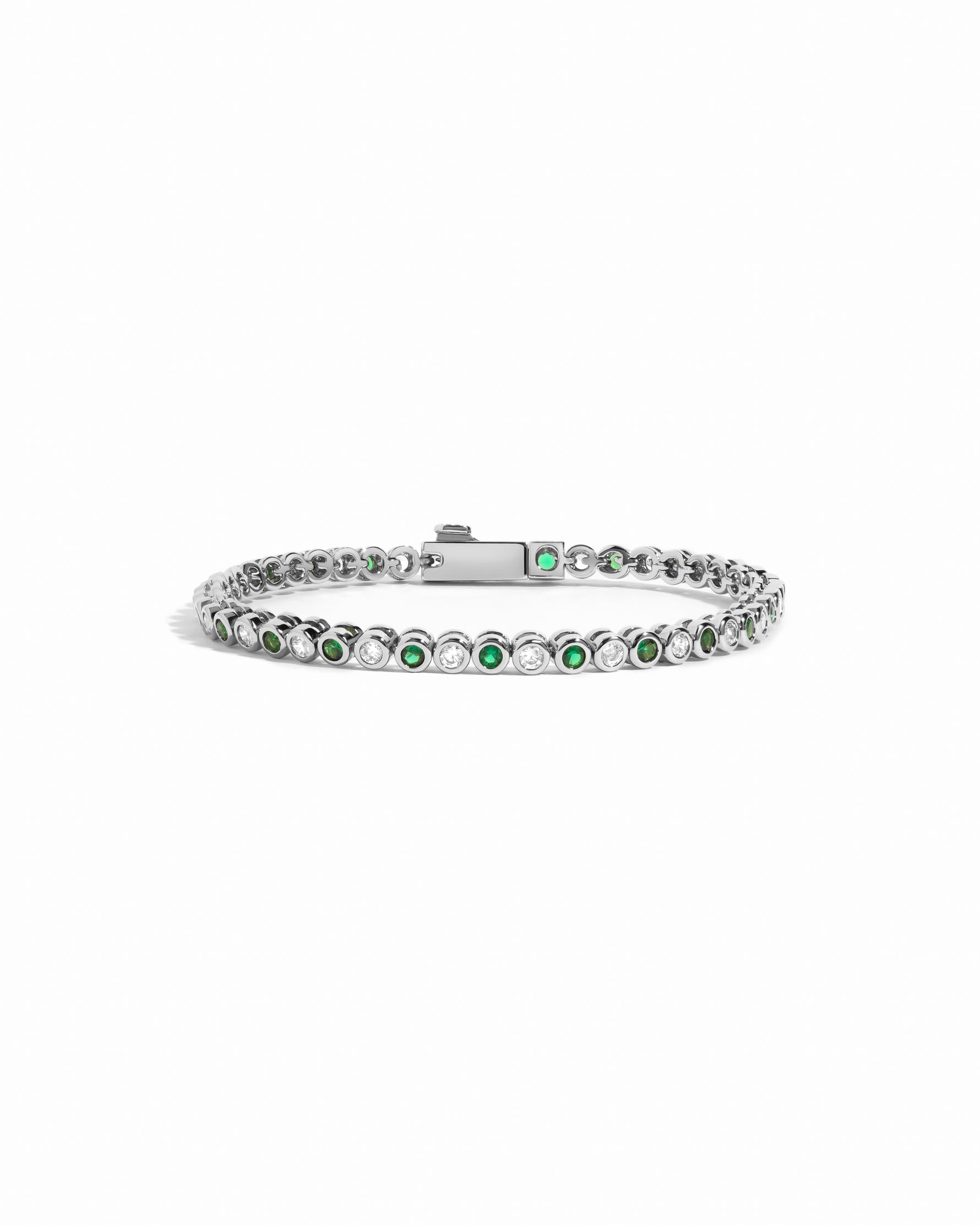 closeup image of white cz and emerald green tennis bracelet in silver