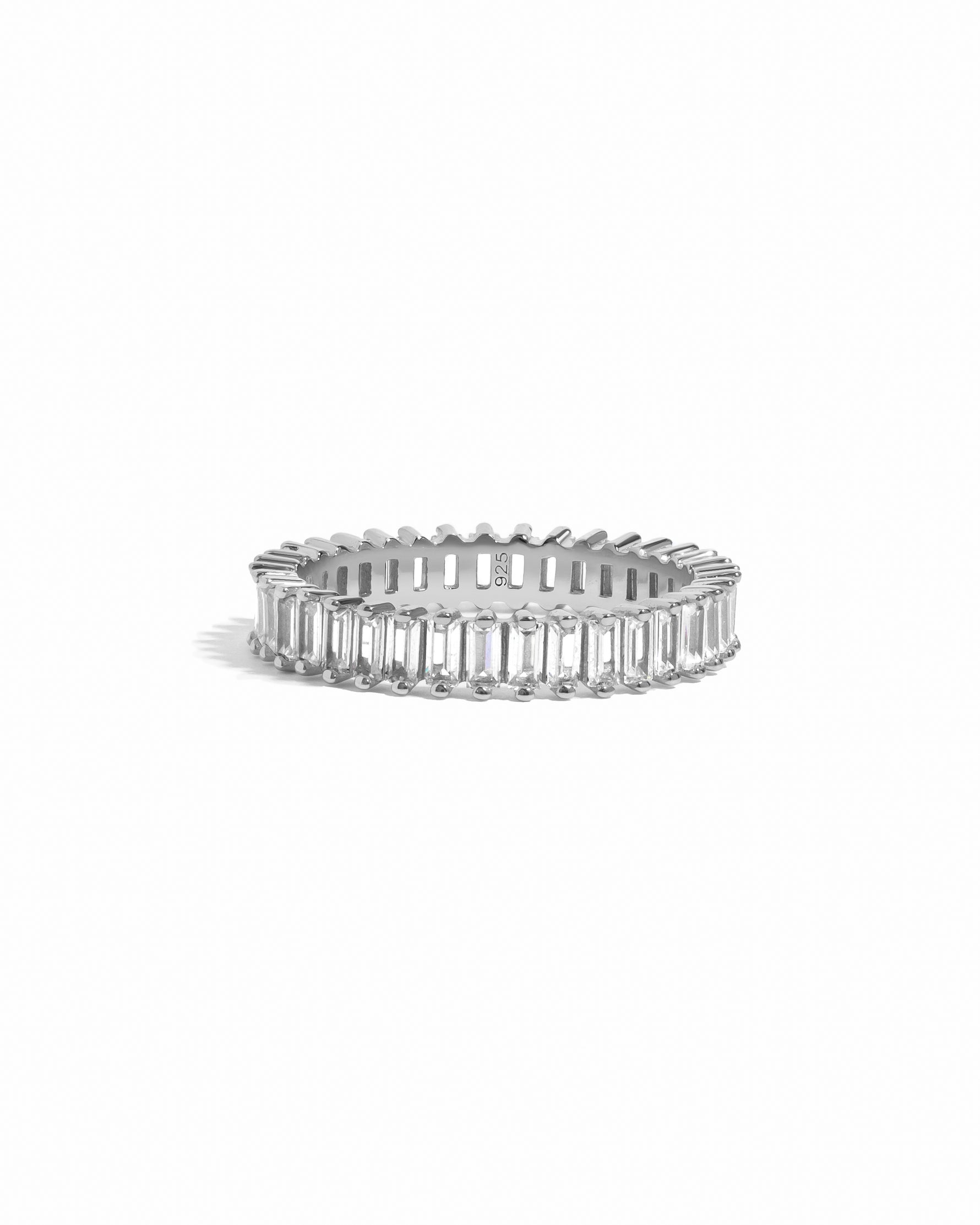 Silver ring with baguette-cut stones on a white background