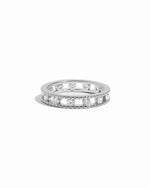Silver ring with small diamonds on a white background