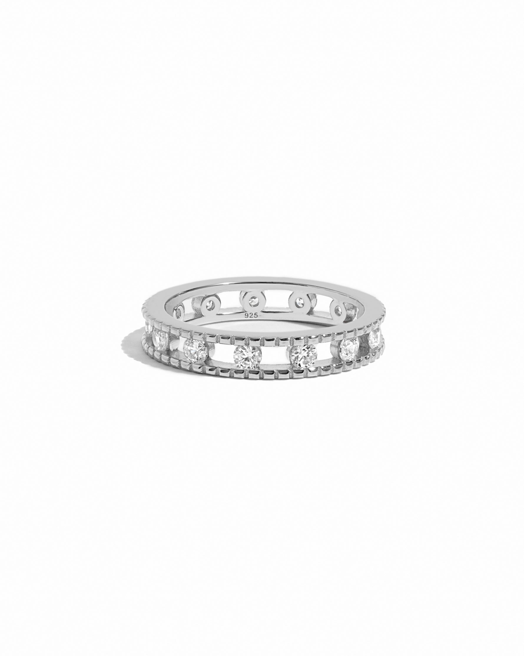 Silver ring with small diamonds on a white background