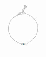 Silver bracelet with a small evil eye charm on a white background