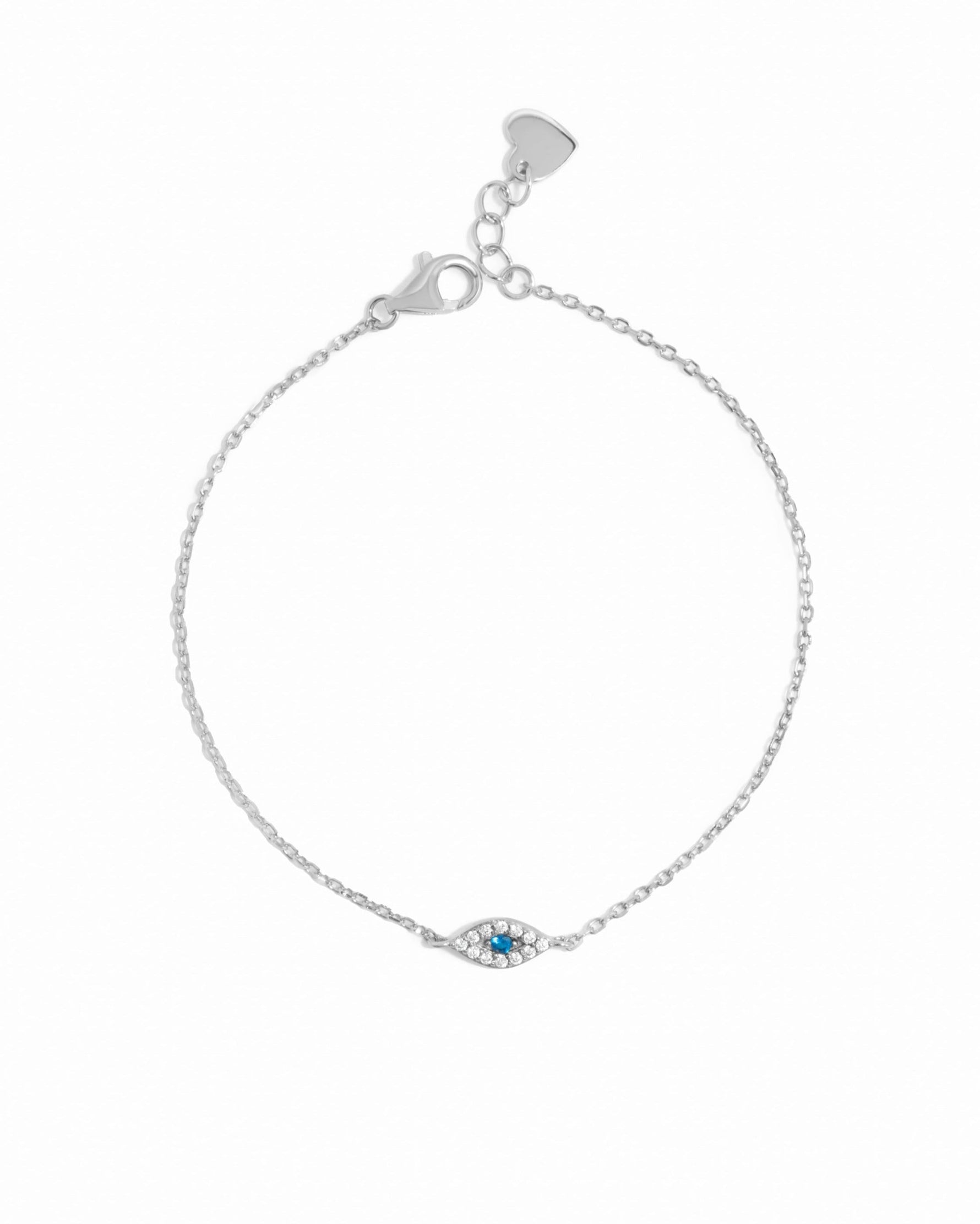 Silver bracelet with a small evil eye charm on a white background