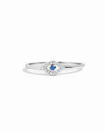 closeup image of silver evil eye ring with blue gemstone and cubic zirconia stones