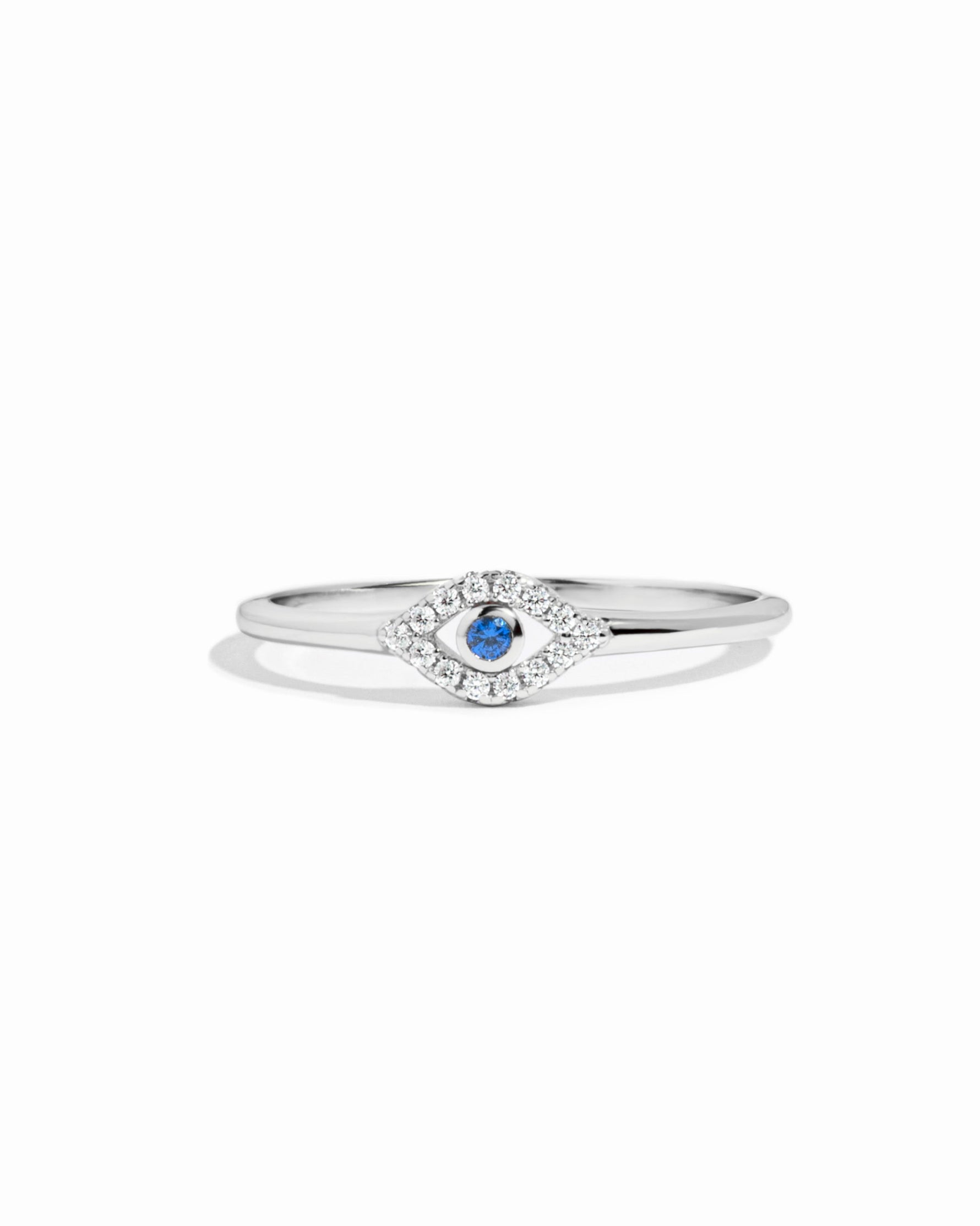 closeup image of silver evil eye ring with blue gemstone and cubic zirconia stones