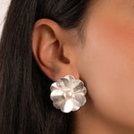 model wearing silver flower statement earrings