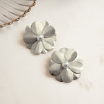 closeup image of statement earrings for the summer featuring a flower earring design