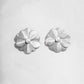 closeup of statement earrings featuring silver flower earrings