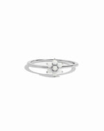 Silver ring with a floral design on a white background